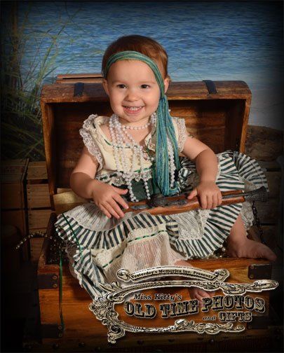 baby dressed up as a pirate girl for an old time photo