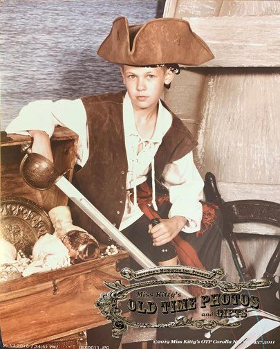 a young boy holding a sward dress as an old time pirate - Miss Old Time Photos and Gifts    Corolla Outer Banks NC