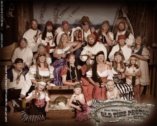 a group of people dressed as pirates are posing for a picture