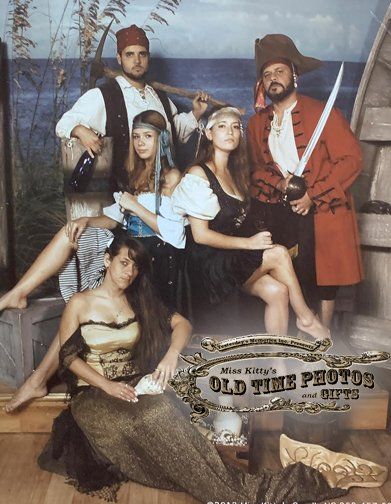 a group of people dressed in pirate costumes are posing for an old time photo