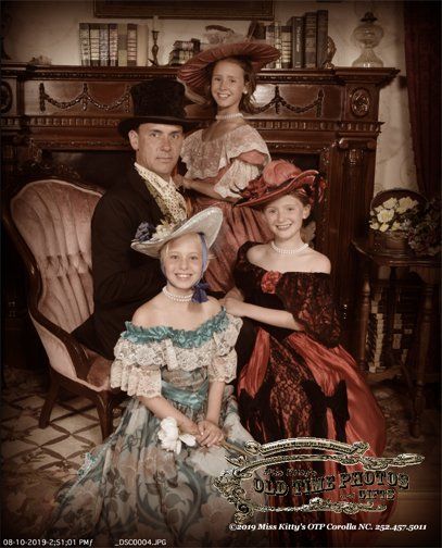 a family posing for a picture in a living room - Miss Kitty's Old Time Photos and Gifts    Corolla Outer Banks NC