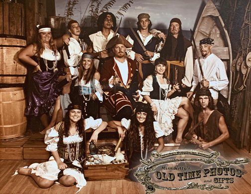 a group of people dressed in pirate costumes are posing for a picture in front of a sign that says old time pluton gifts