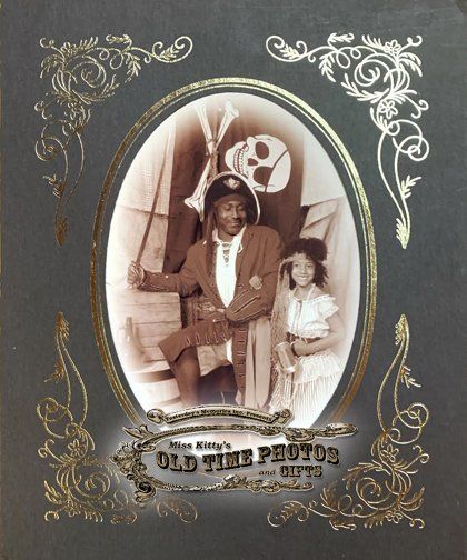 an old time photo of a pirate man and a little girl  - Miss Kitty's Old Time Photos and Gifts    Corolla Outer Banks NC