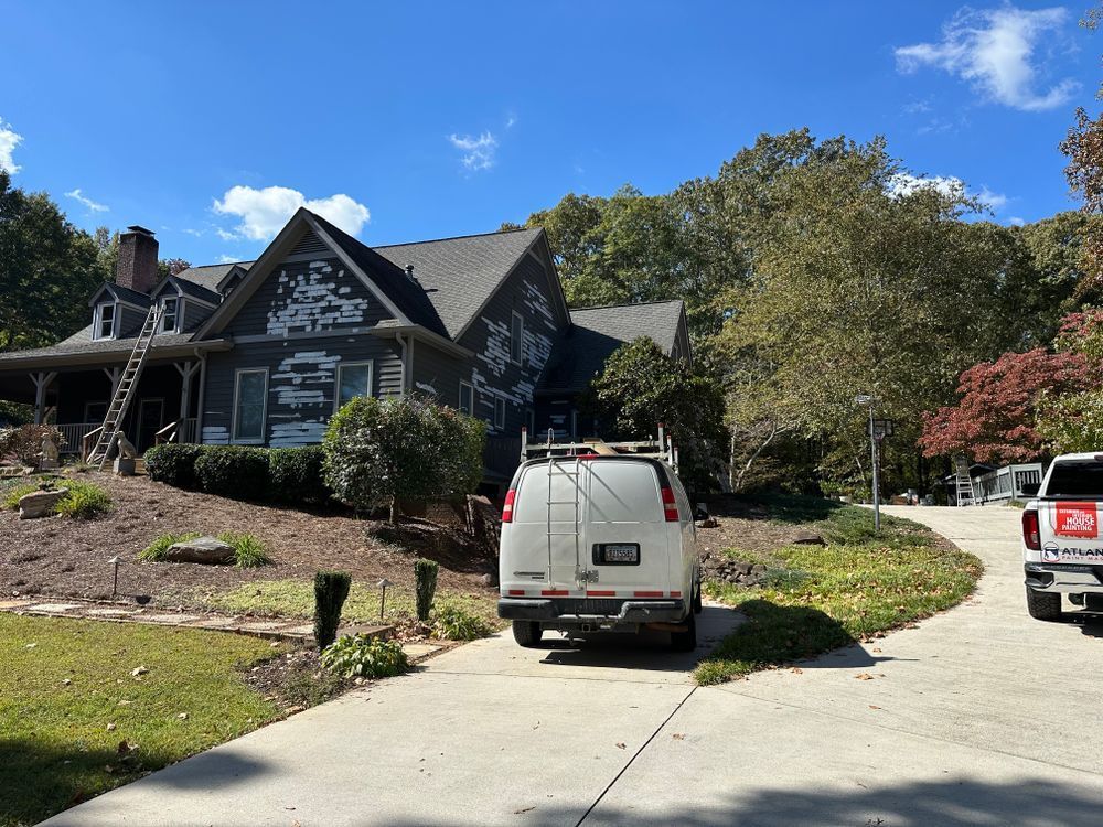 A white van is parked in front of a large house.