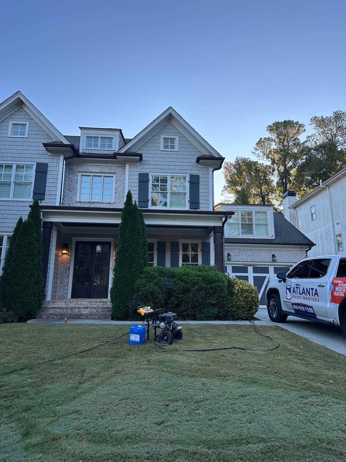 A large house with a car parked in front of it.