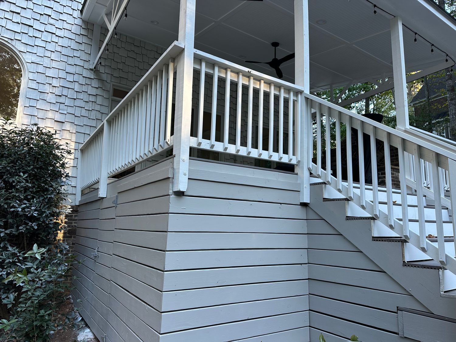 A white house with a porch and stairs