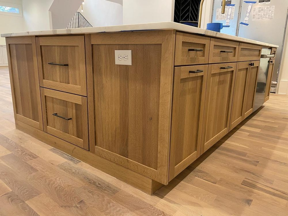 A kitchen island with wooden cabinets and drawers.