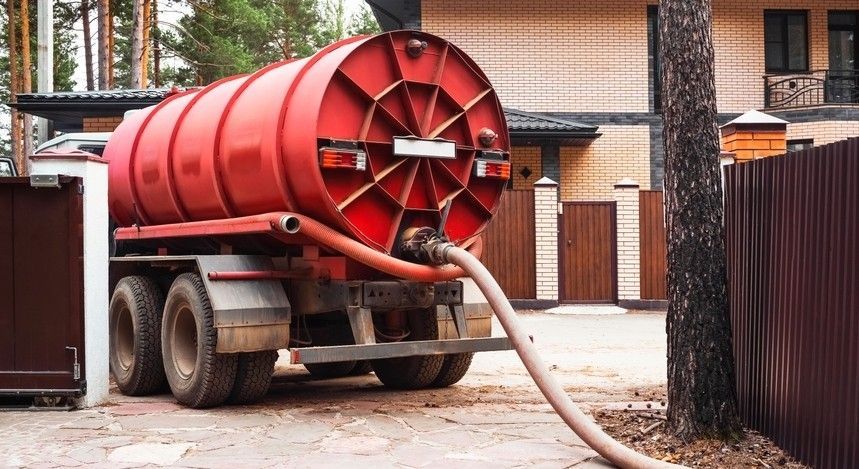 Truck With a Hose Attached to It is Parked in Front of a House — Wild Water Delivery in Beerwah, QLD