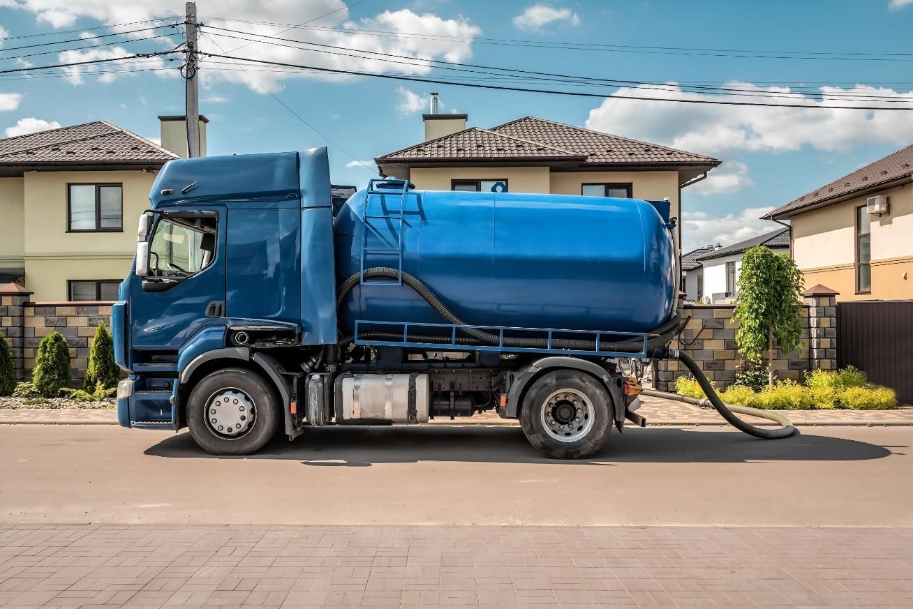 A Blue Septic Truck is Parked on the Side of the Road in Front of a House — Wild Water Delivery in Mooloolah, QLD