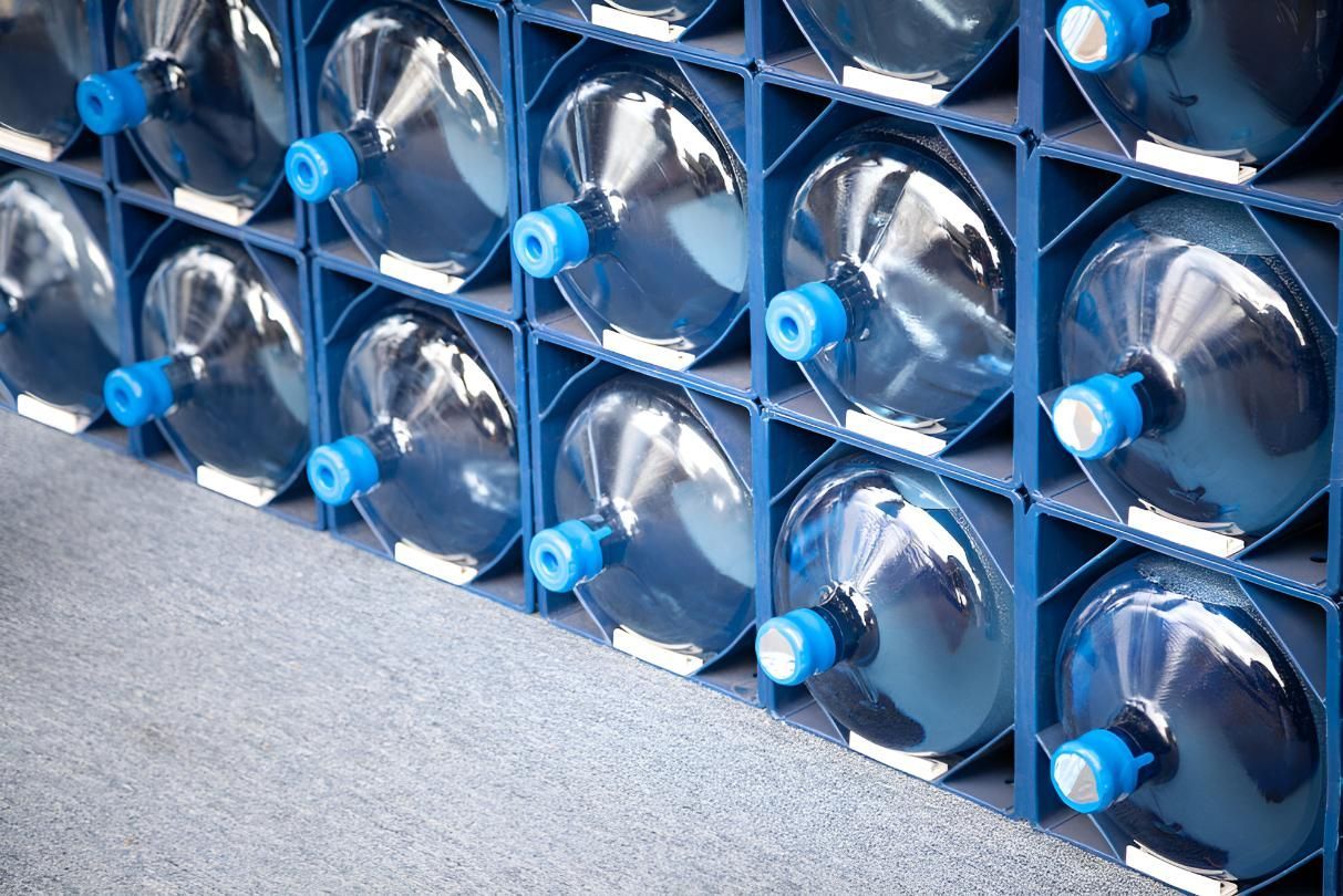 A Row of Water Bottles Stacked on Top of Each Other on a Shelf — Wild Water Delivery in Mooloolah, QLD
