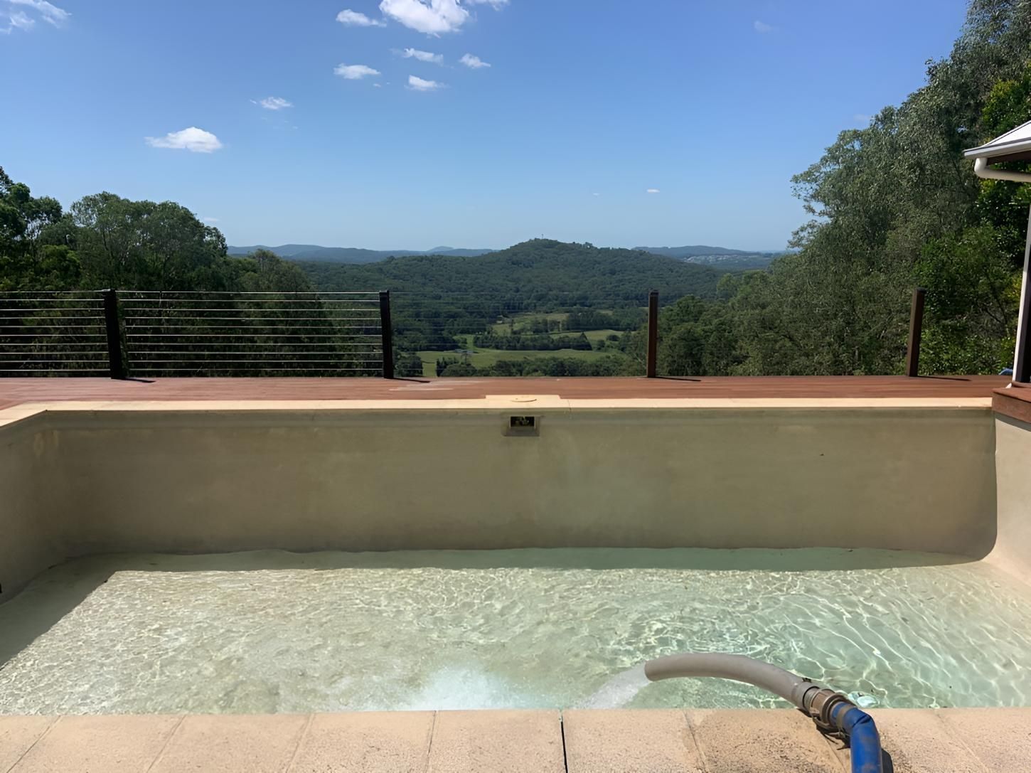 A Swimming Pool With a View of a Valley and Mountains — Wild Water Delivery in Mooloolah, QLD