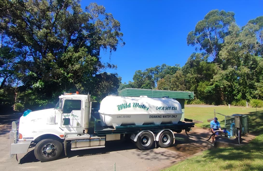 A White Truck is Parked in a Parking Lot With Trees in the Background — Wild Water Delivery in Montville, QLD