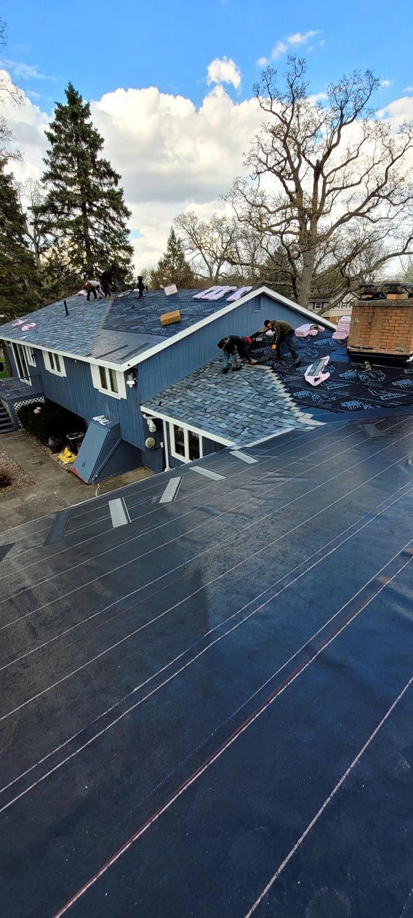 An aerial view of a house with a roof that is being installed.