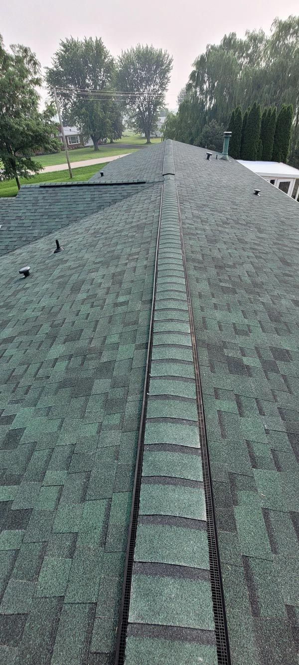 A close up of a roof with a drain on it.