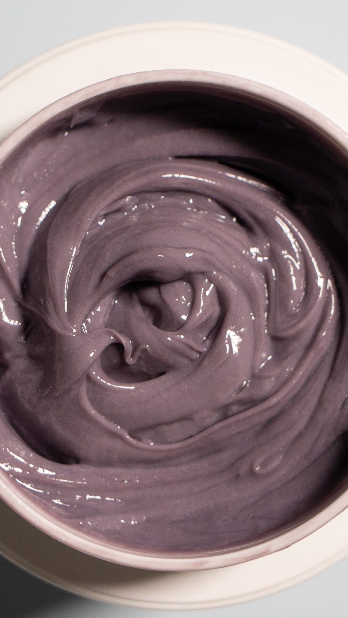 A White Bowl Filled With a Purple Creamy Substance — Innovative Hair Salon in Gosford, NSW