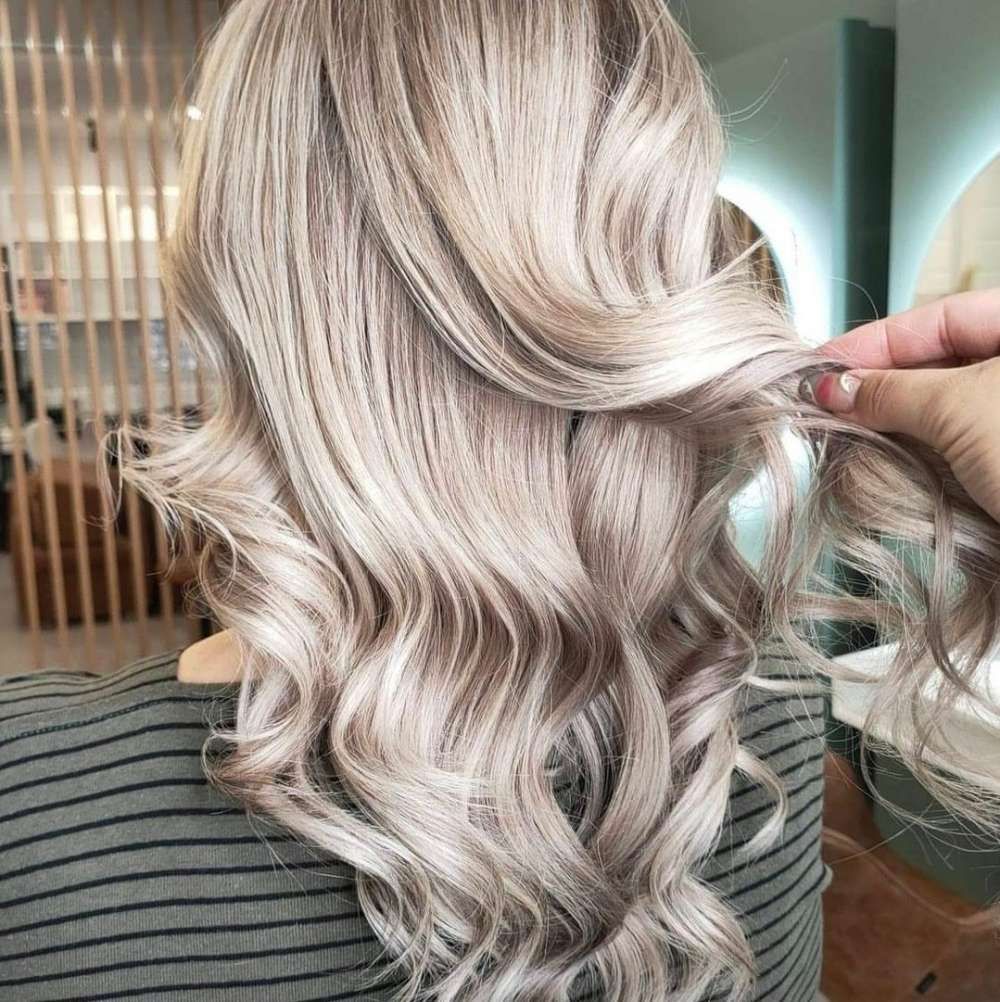 A Woman is Getting Her Hair Done in a Salon — Experienced Hair Stylist in Gosford, NSW