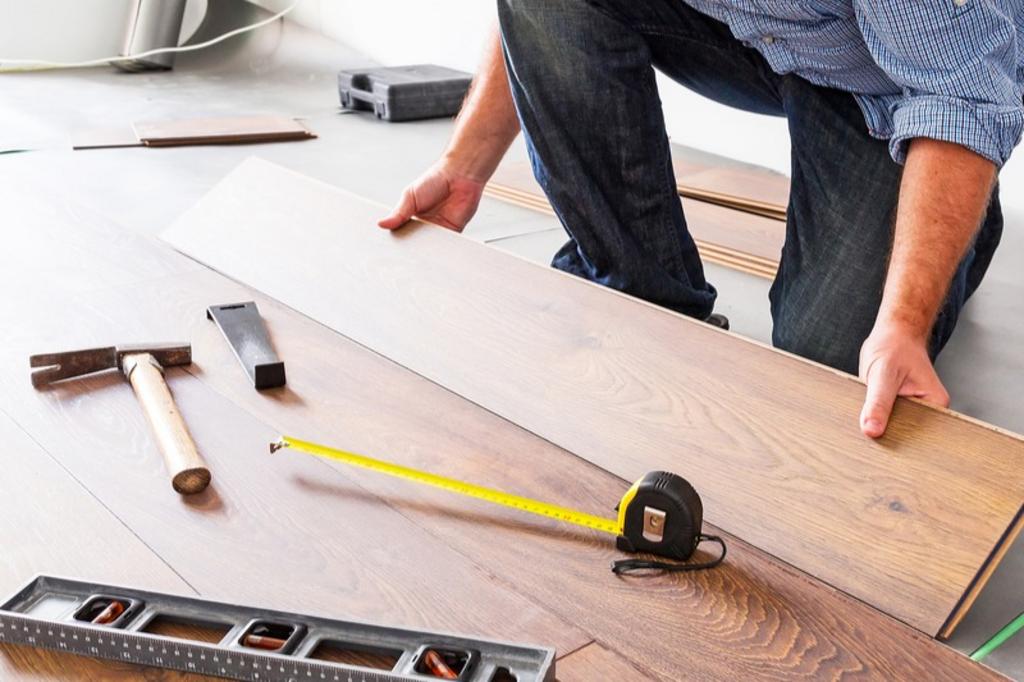 Man installing new laminated wooden floor