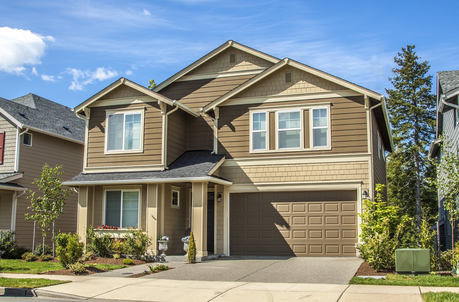 luxury family house with landscaping on the front and blue sky on background