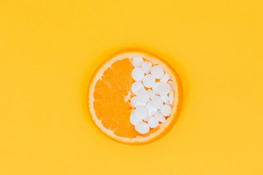 Orange slice with white candies on a bright yellow background