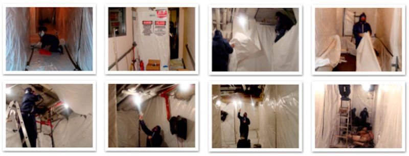 Workers in protective gear performing asbestos removal in an enclosed space.
