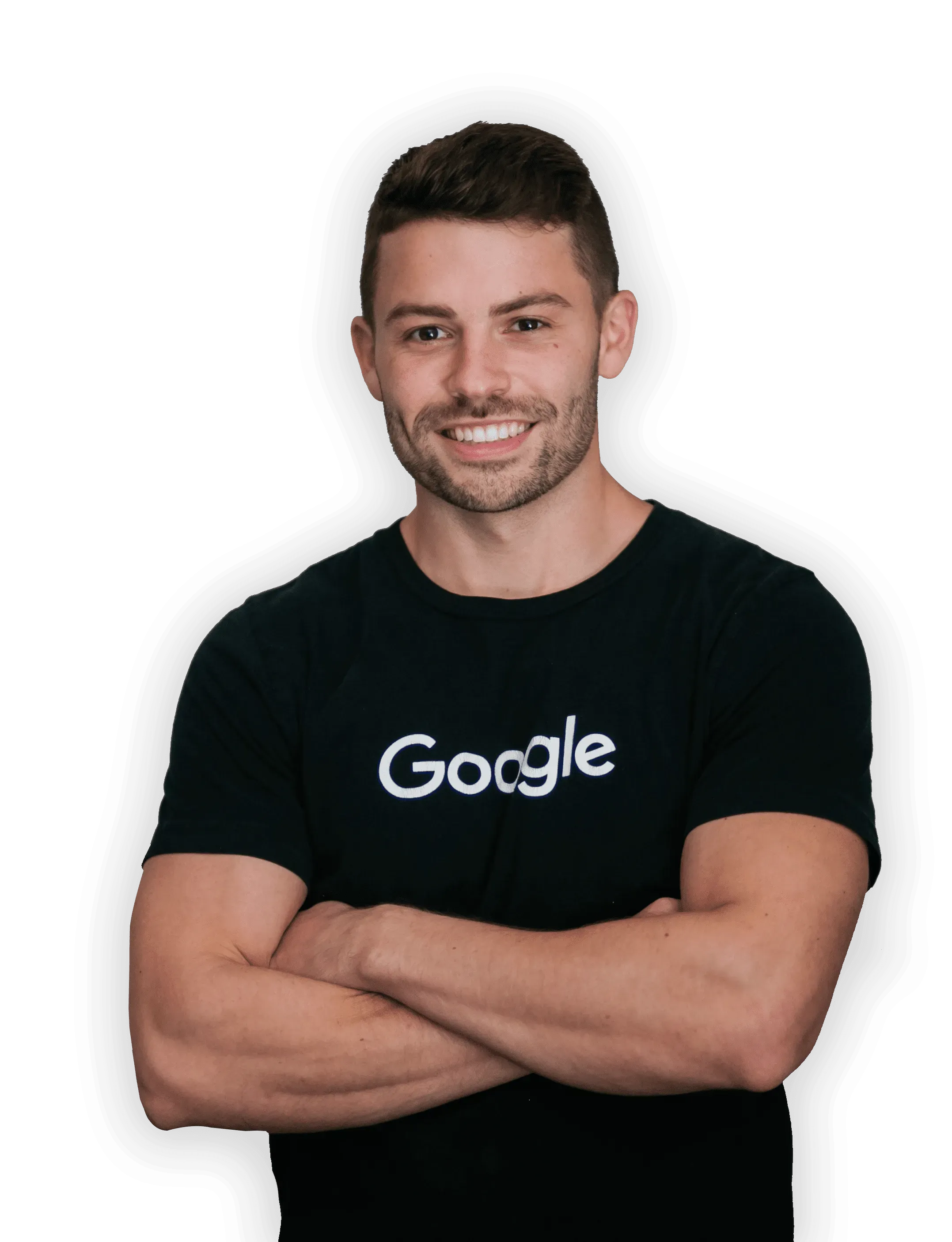 A man wearing a google t-shirt is standing with his arms crossed.