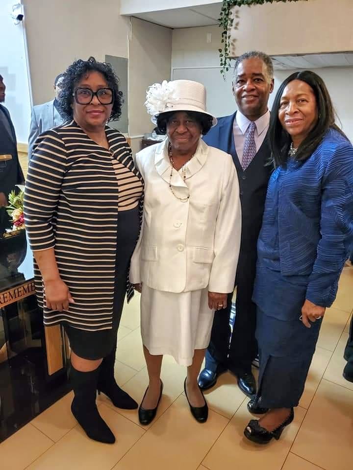 a group of people standing next to each other in a room .