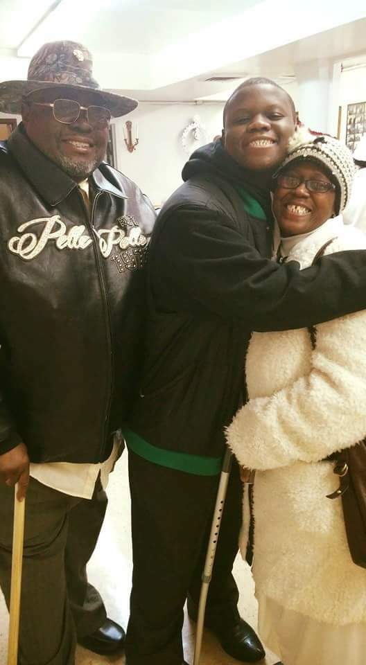 a man in a polo jacket is hugging a woman in a white coat .