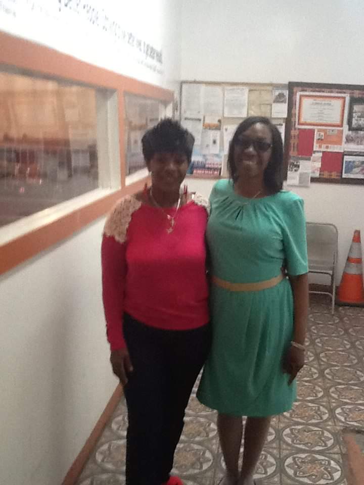 two women standing next to each other in a hallway