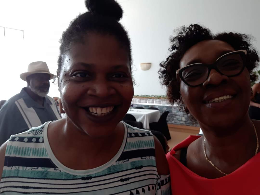 two women are posing for a picture and smiling for the camera