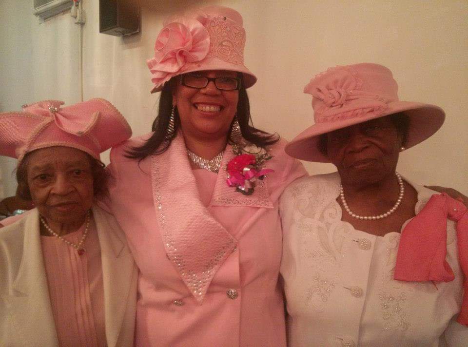three women wearing pink hats are posing for a picture