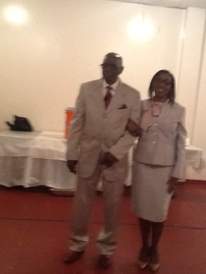 a man and a woman are standing next to each other in a room .