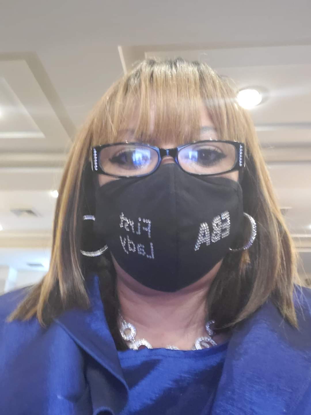 a woman wearing glasses and a mask that says ab on it