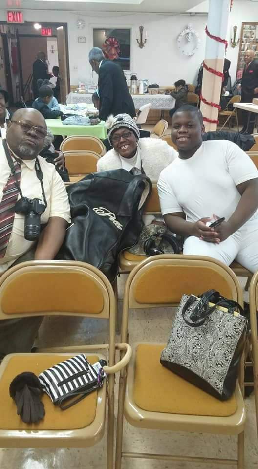 a group of people are sitting in chairs in a room .