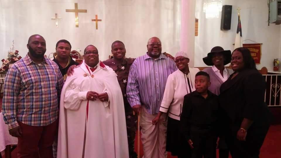 a group of people are posing for a picture in a church .