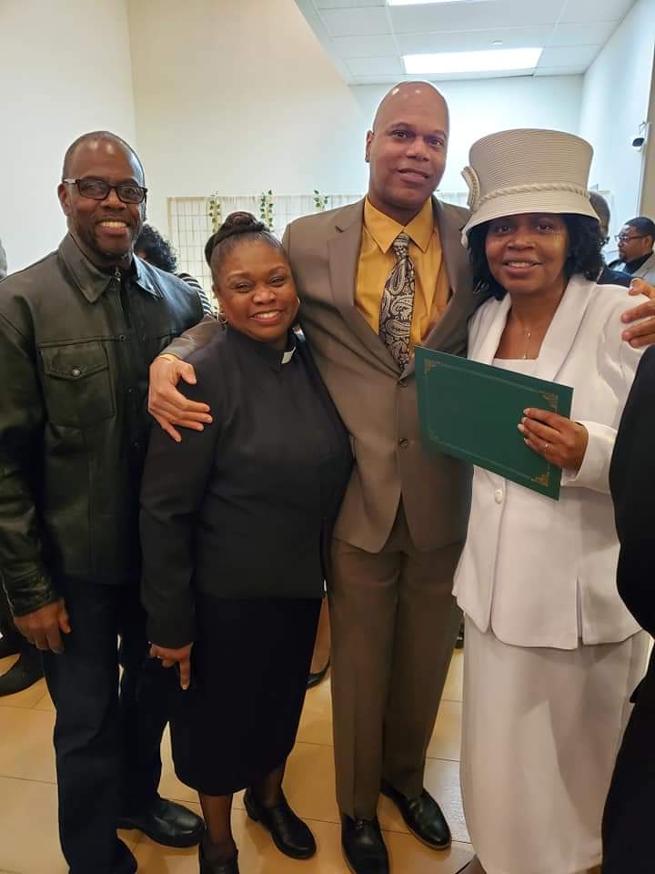 a group of people are posing for a picture in a room .