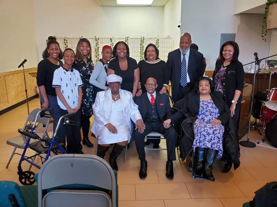 a group of people are posing for a picture in a room .
