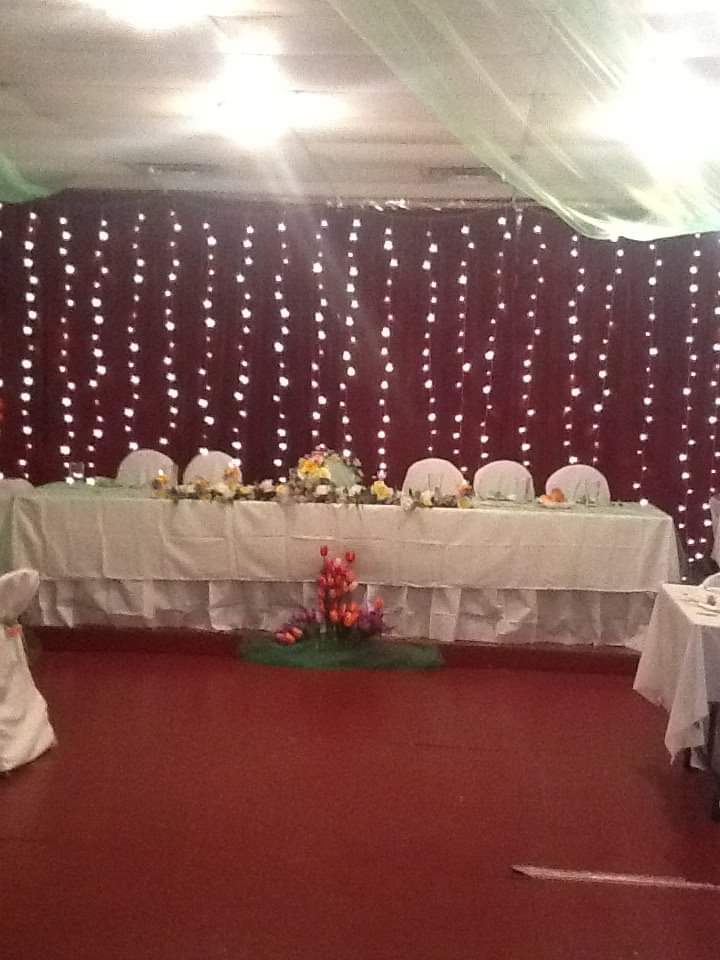 a long table with flowers on it in a room