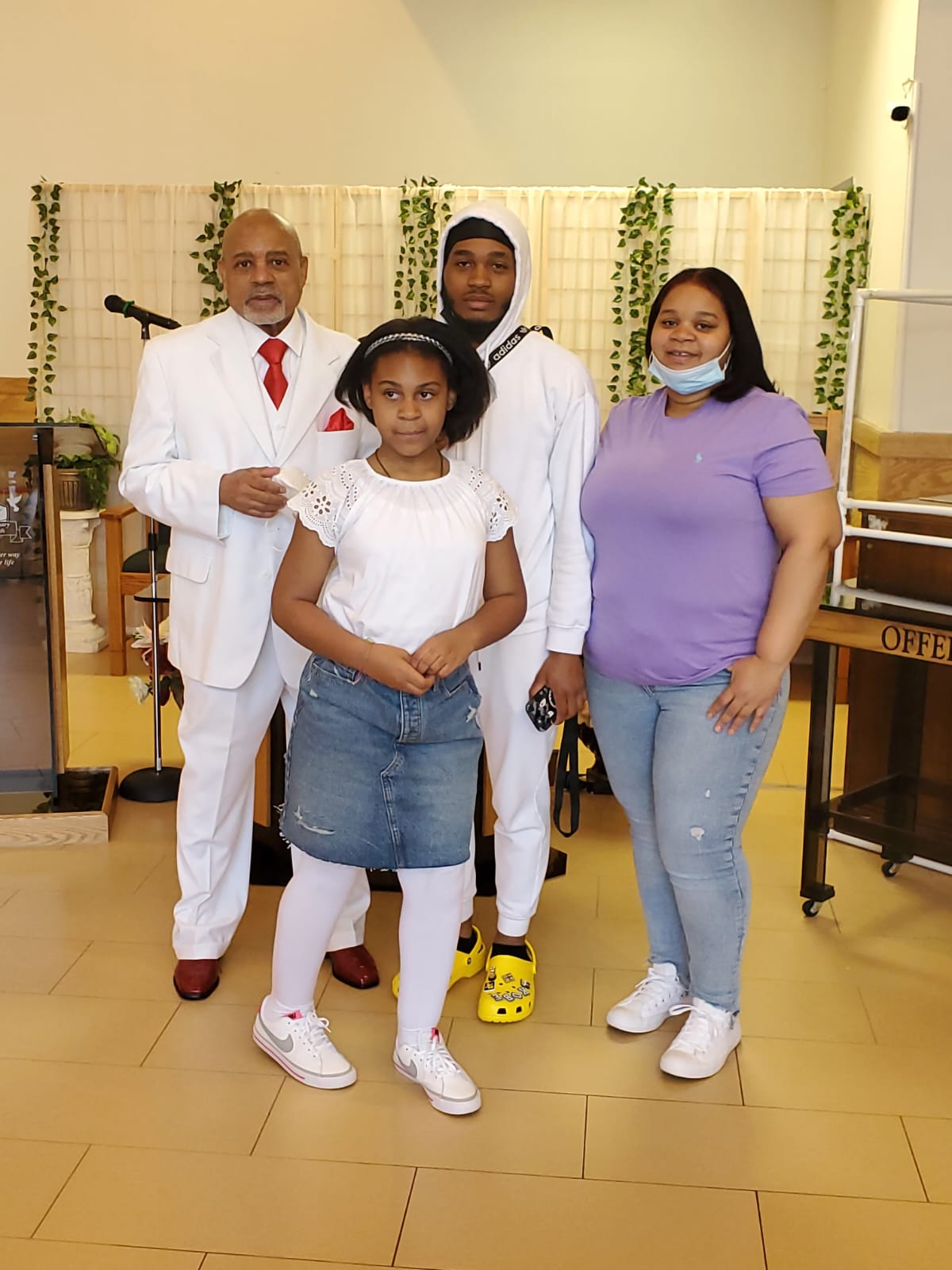 a group of people standing next to each other in a room .