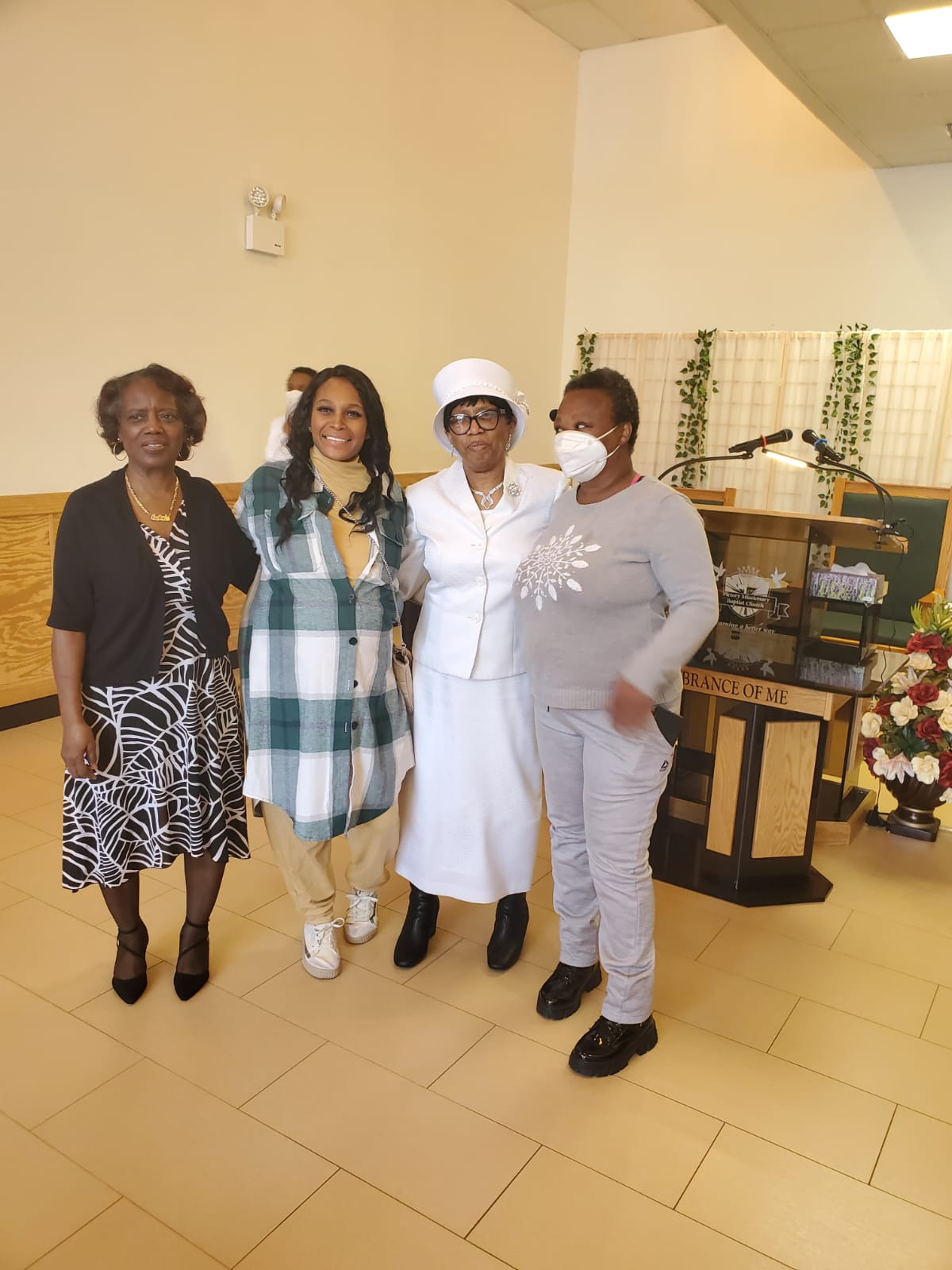 a group of women are posing for a picture in a room .