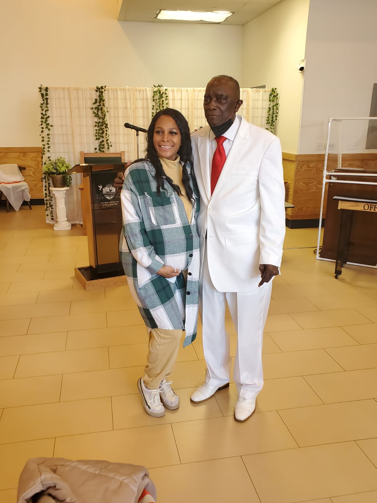 a man and a woman are posing for a picture in a church .