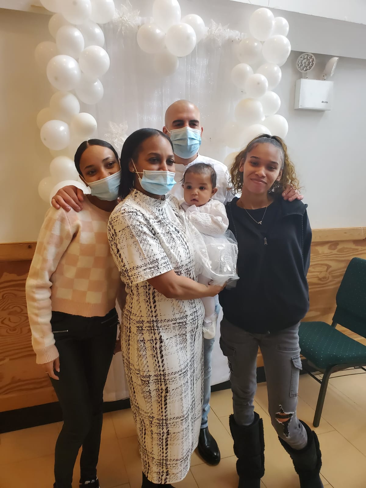 a group of people wearing face masks are posing for a picture .