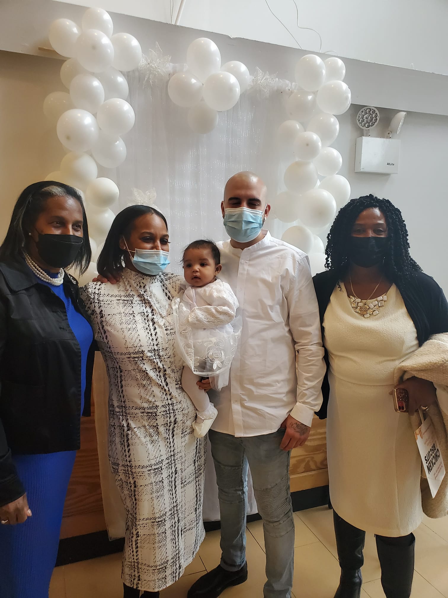 a group of people wearing face masks are posing for a picture .