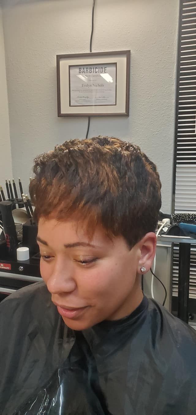 Woman with short, textured brown hair, in a salon setting.