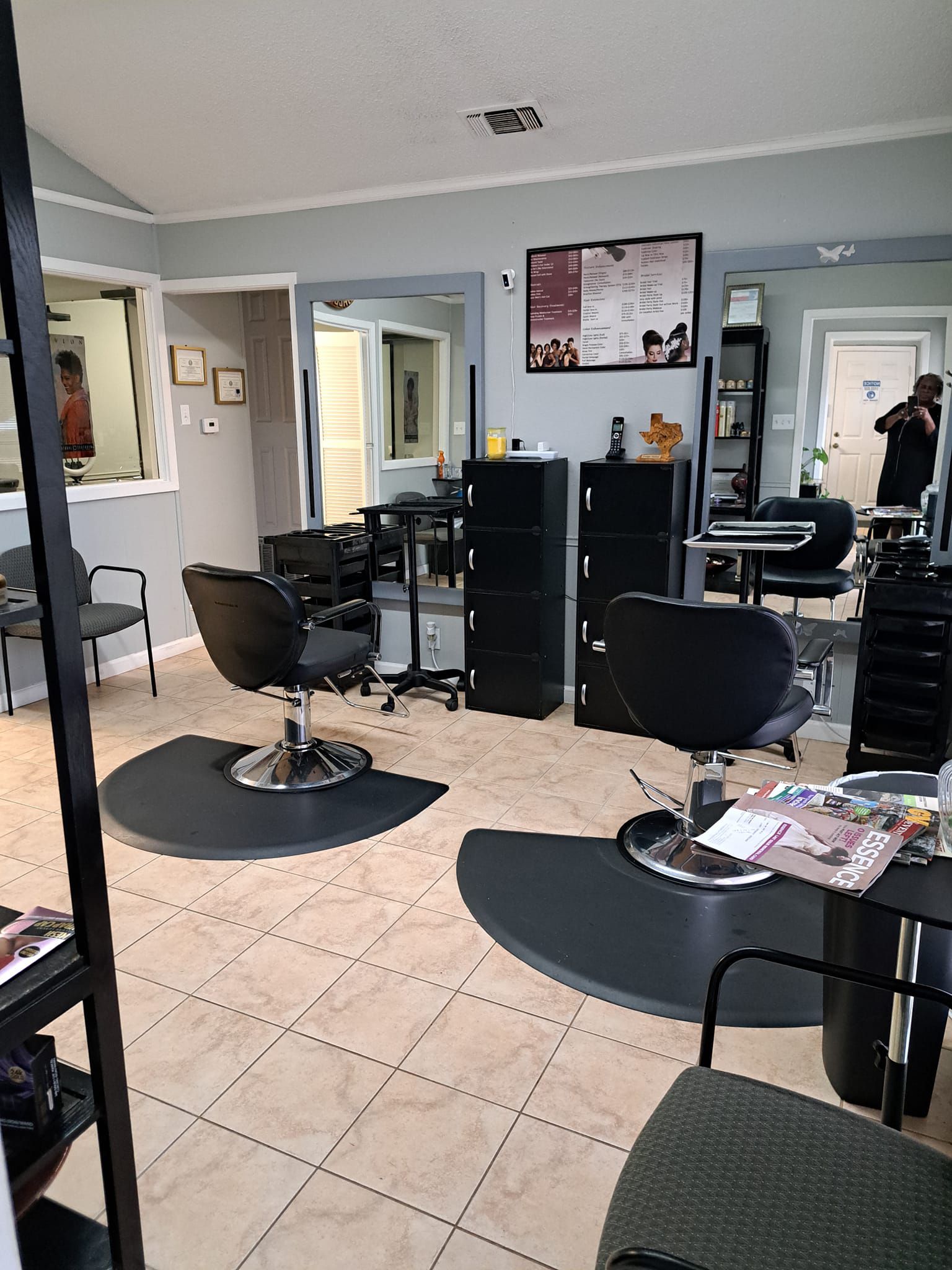 Hair salon interior with styling chairs, mirrors, and product displays.