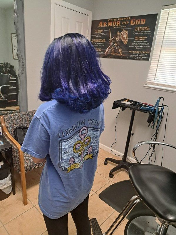 Six people stand outside a building with an ornate gate. They are dressed in business attire.