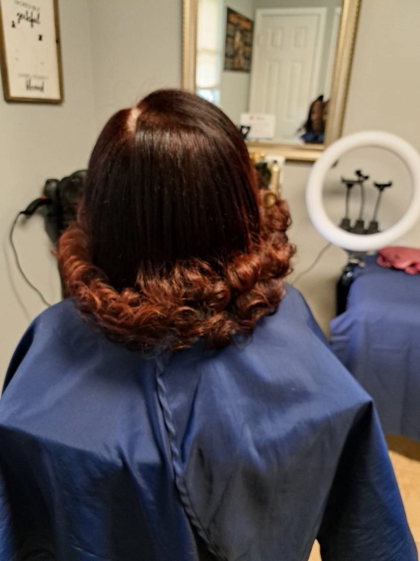 Group of people standing outside a building with an open iron gate. They are smiling.