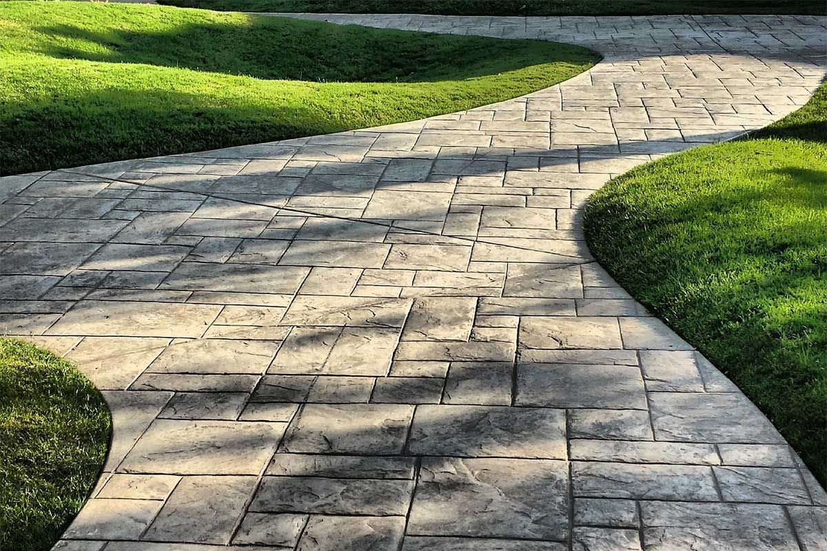 A stamped concrete walkway designed to look like bricks.