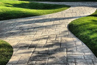 A stamped concrete walkway designed to look like bricks.