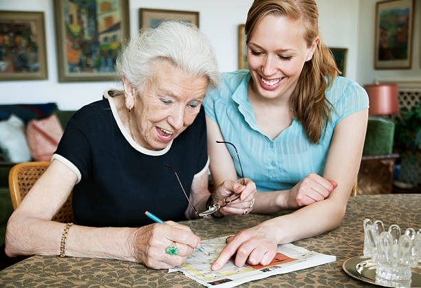 Woman Helping Elderly To Write - Branford, CT - Branford Hills Homecare Services 