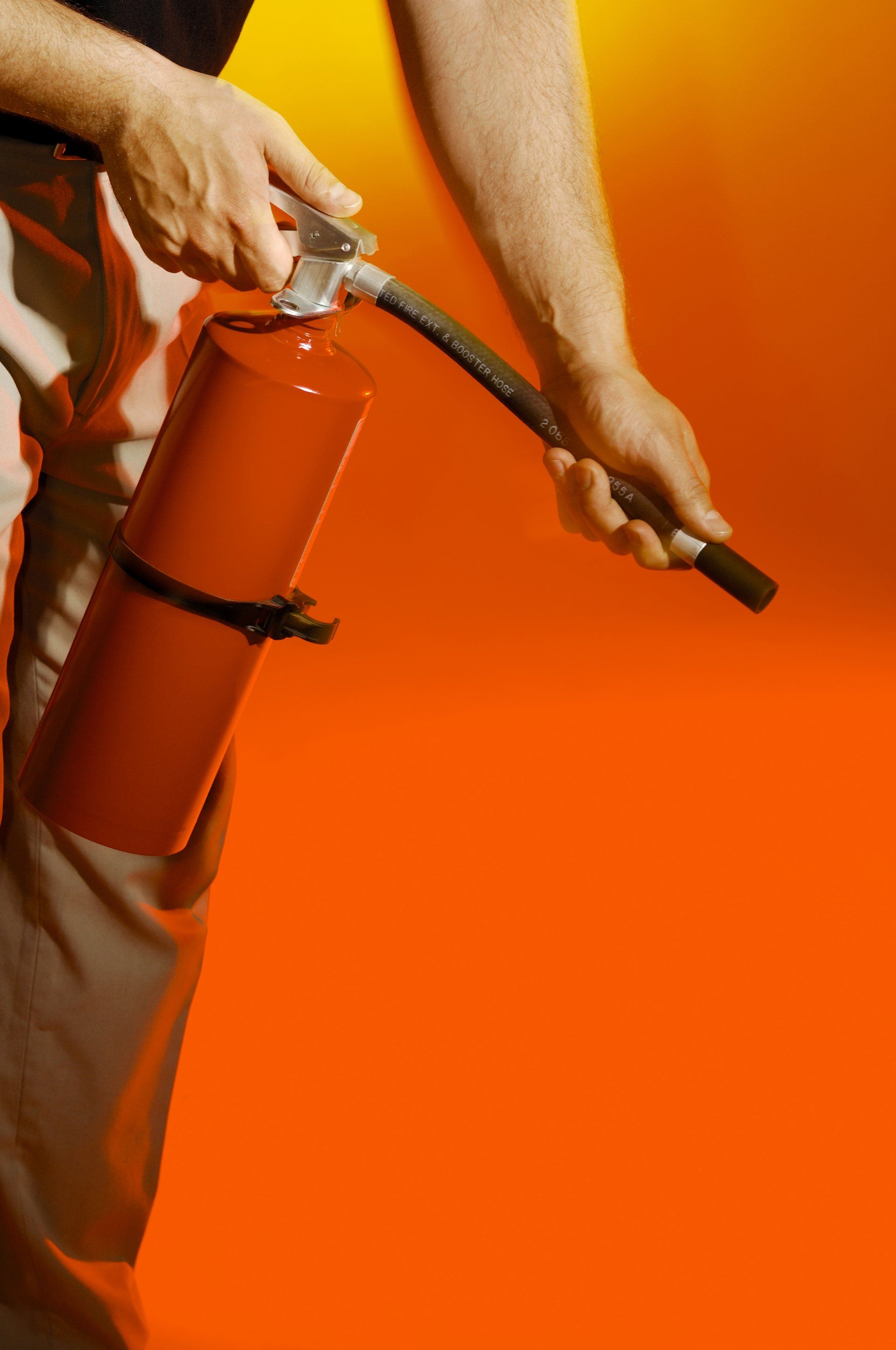 Man holding fire extinguisher — Dandridge, TN — Rapid Fire Equipment Inc.